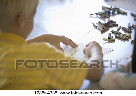 Close-up of a boy drawing with crayons View Large Photo Image Stock Photography - Close-up of a boy drawing with crayons. Fotosearch
