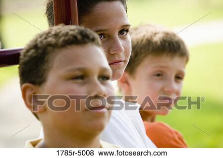 Stock Photo - Close-up of a boy with friends in the background. Fotosearch
