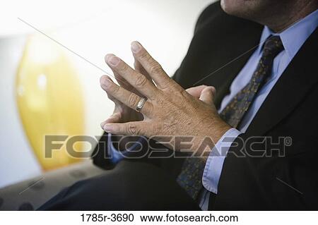 Stock Image - Close up of a businessman's hands. Fotosearch