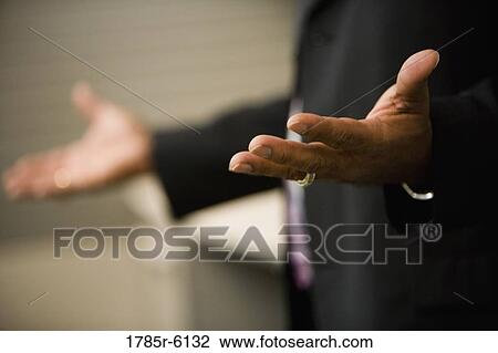 Stock Image - Close-up of a businessman's hands gesturing. Fotosearch