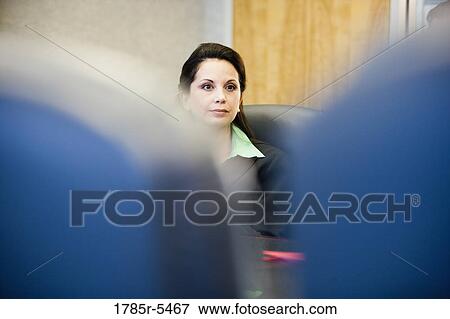 Close-up of a businesswoman viewed between two chairs View Large Photo Image Stock Photo - Close-up of a businesswoman viewed between two chairs. Fotosearch