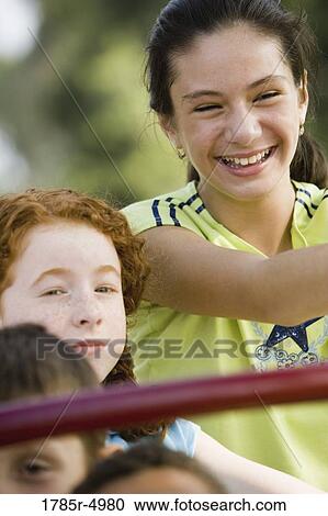 Close-up of a children posing on monkey bars at a playground View Large Photo Image Stock Image - Close-up of a children posing on monkey bars at a playground. Fotosearch