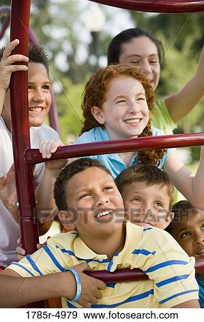 Close-up of a children posing on monkey bars at a playground View Large Photo Image Stock Photo - Close-up of a children posing on monkey bars at a playground. Fotosearch