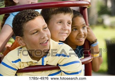 Close-up of a children posing on monkey bars at a playground View Large Photo Image Stock Photograph - Close-up of a children posing on monkey bars at a playground. Fotosearch