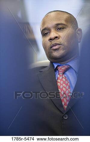 Close-up of a contemplative businessman View Large Photo Image Picture - Close-up of a contemplative businessman. Fotosearch