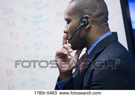 Close-up of a contemplative businessman with headset View Large Photo Image Stock Image - Close-up of a contemplative businessman with headset. Fotosearch