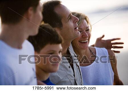 Stock Image - Close-up of a family standing side by side. Fotosearch
