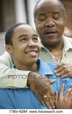 Close-up of a father embracing his son View Large Photo Image Picture - Close-up of a father embracing his son. Fotosearch
