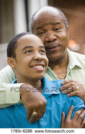 Stock Photograph - Close-up of a father embracing his son. Fotosearch