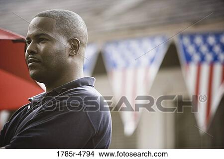 Picture - Close-up of a man with 4th of July decorations in background. Fotosearch