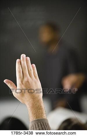Close-up of a raised hand in class View Large Photo Image Stock Photo - Close-up of a raised hand in class. Fotosearch