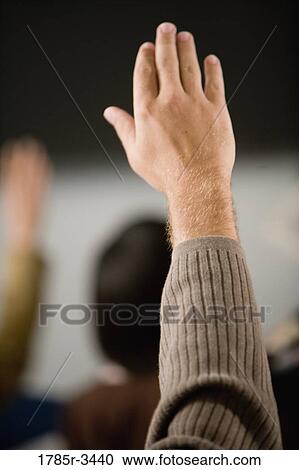Stock Image - Close-up of a raised human hand. Fotosearch