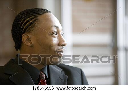 Close-up of a smiling businessman View Large Photo Image Stock Photograph - Close-up of a smiling businessman. Fotosearch