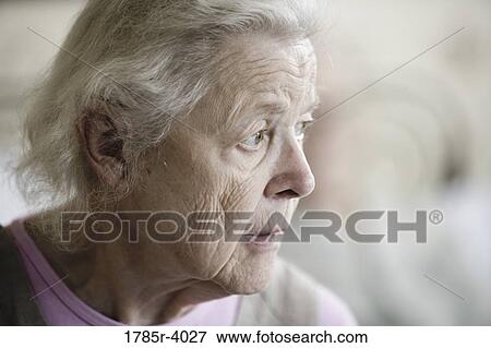 Close-up of a stoic and pensive senior woman staring into space View Large Photo Image Stock Photo - Close-up of a stoic and pensive senior woman staring into space. Fotosearch