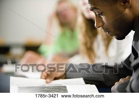 Stock Image - Close-up of a student reading. Fotosearch