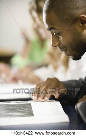 Close-up of a student reading View Large Photo Image Stock Image - Close-up of a student reading. Fotosearch