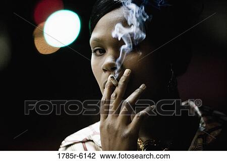Stock Image - Close-up of a woman smoking a cigarette. Fotosearch