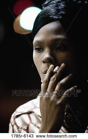 Close-up of a woman smoking a cigarette View Large Photo Image Stock Image - Close-up of a woman smoking a cigarette. Fotosearch
