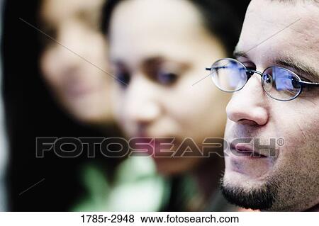 Stock Photo - Close-up of a young man wearing glasses. Fotosearch
