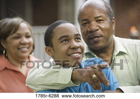 Stock Photo - Close up of African American boy with parents. Fotosearch