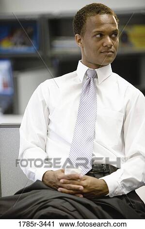 Close up of businessman sitting in office View Large Photo Image Stock Image - Close up of businessman sitting in office. Fotosearch