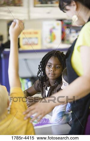 Close up of children and teacher in classroom View Large Photo Image Stock Photography - Close up of children and teacher in classroom. Fotosearch