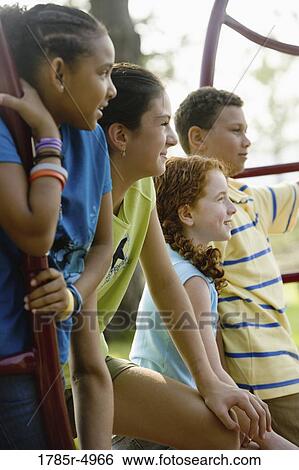 Close up of children together on a playground View Large Photo Image Stock Photograph - Close up of children together on a playground. Fotosearch