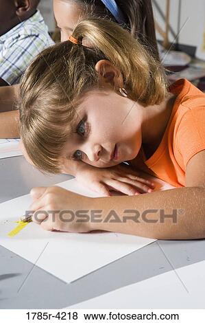Close-up of girl drawing in class View Large Photo Image Stock Photo - Close-up of girl drawing in class. Fotosearch