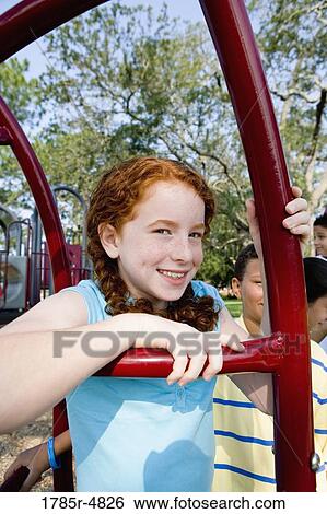 Close up of girl on playground View Large Photo Image Stock Photograph - Close up of girl on playground. Fotosearch