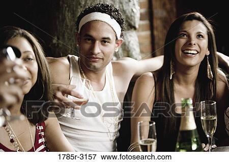 Close-up of group of young friends socializing View Large Photo Image Stock Photo - Close-up of group of young friends socializing. Fotosearch