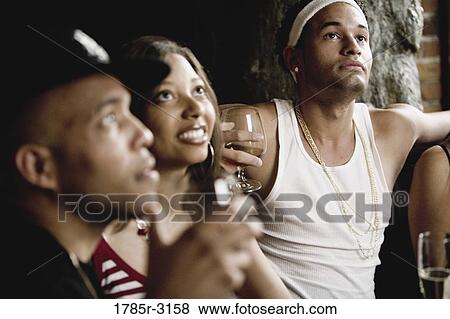 Close-up of group of young friends socializing View Large Photo Image Stock Photo - Close-up of group of young friends socializing. Fotosearch