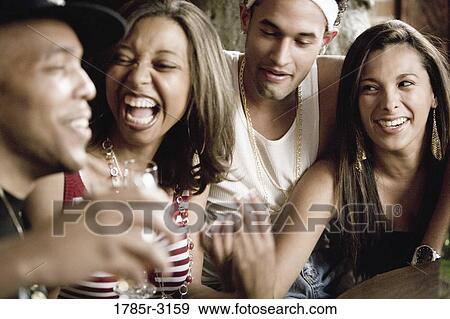Close-up of group of young friends socializing View Large Photo Image Stock Photo - Close-up of group of young friends socializing. Fotosearch