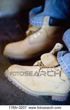 Stock Photo - Close-up of heavy boots being worn. Fotosearch