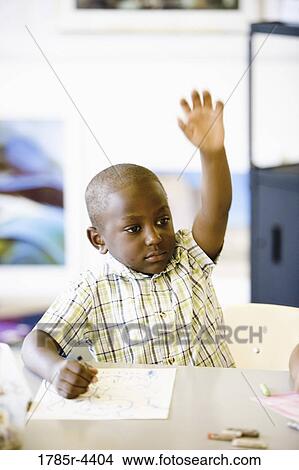 Picture - Close up of little boy raising his hand. Fotosearch