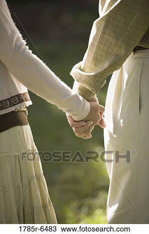 Close-up of man's and woman's hands holding View Large Photo Image Stock Image - Close-up of man's and woman's hands holding. Fotosearch