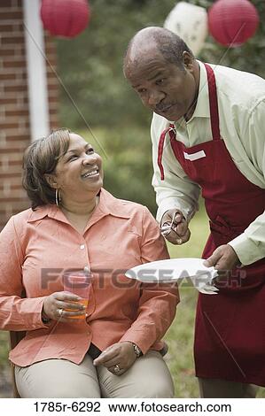 Close up of mature couple at backyard barbeque View Large Photo Image Stock Image - Close up of mature couple at backyard barbeque. Fotosearch