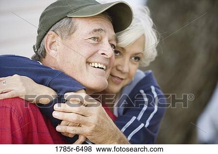 Stock Photo - Close-up of mature couple embracing. Fotosearch