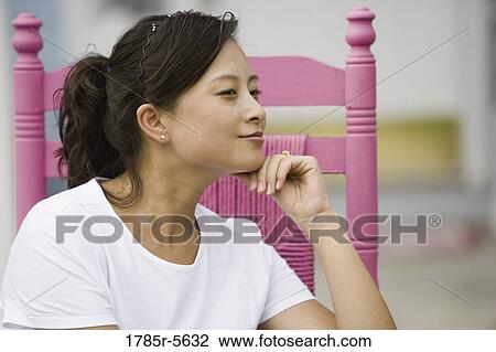 Close-up of pretty young Asian woman thinking View Large Photo Image Stock Image - Close-up of pretty young Asian woman thinking. Fotosearch