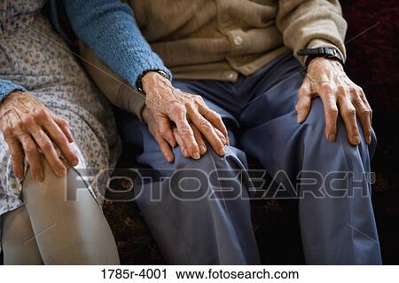 Close-up of senior couple holding hands while sitting View Large Photo Image Stock Image - Close-up of senior couple holding hands while sitting. Fotosearch
