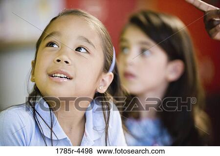 Stock Photo - Close up of two little girls side by side. Fotosearch