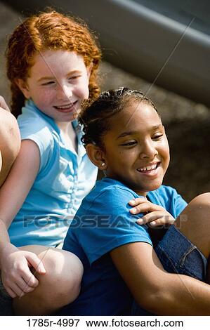 Close-up of two smiling girls View Large Photo Image Stock Photo - Close-up of two smiling girls. Fotosearch