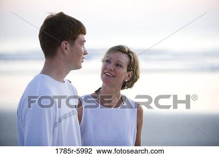 Close-up of woman conversing with teenage son at the beach View Large Photo Image Stock Image - Close-up of woman conversing with teenage son at the beach. Fotosearch