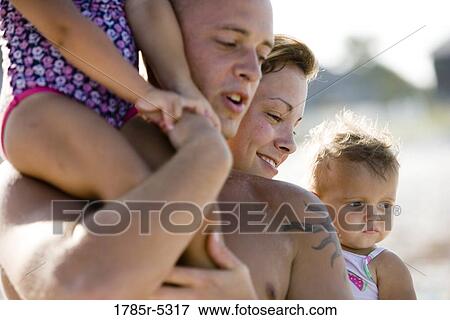 Close up of young family at the beach View Large Photo Image Stock Photo - Close up of young family at the beach. Fotosearch