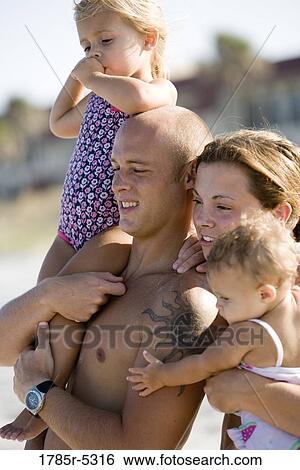 Close up of young family at the beach View Large Photo Image Stock Photograph - Close up of young family at the beach. Fotosearch
