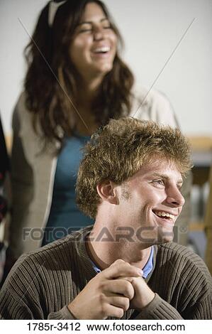 Stock Image - Close up of young peple smiling. Fotosearch