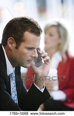 Stock Photo - Close-up view of a business man using a mobile phone. Fotosearch