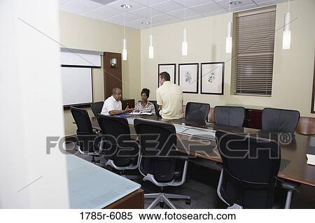 Colleagues working together in a conference room View Large Photo Image Stock Photography - Colleagues working together in a conference room. Fotosearch