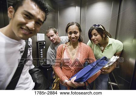 College students looking out from elevator View Large Photo Image Picture - College students looking out from elevator. Fotosearch