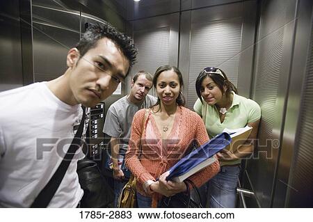 College students looking out from elevator View Large Photo Image Stock Image - College students looking out from elevator. Fotosearch