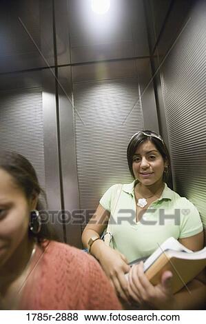 College students riding elevator View Large Photo Image Stock Photo - College students riding elevator. Fotosearch